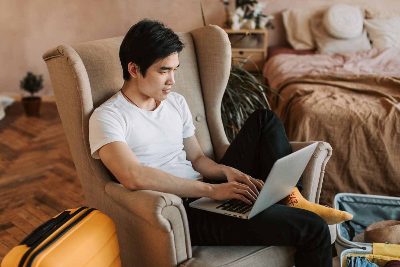 A guest using a laptop in a hotel room