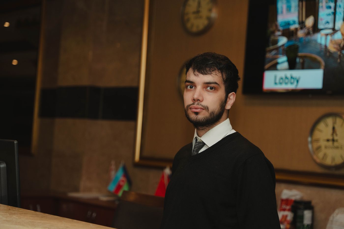 A receptionist at work in a hotel lobby
