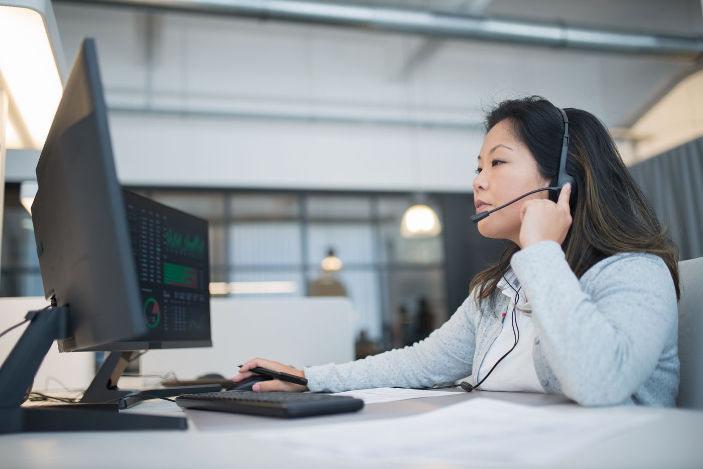 A reservations agent on a headset at a computer