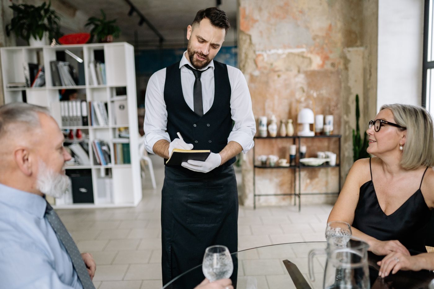 A server taking an order at a restaurant table